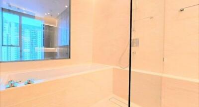 Modern bathroom with large bathtub and glass shower enclosure