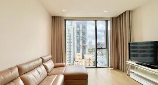 Modern living room with a large window offering city views