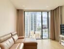 Well-lit living room with a large window, high rise view, and modern furniture