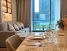 Contemporary living room with a dining area and city view