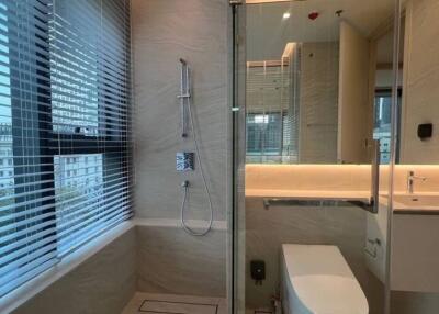 Modern bathroom with large window, shower, and white vanity