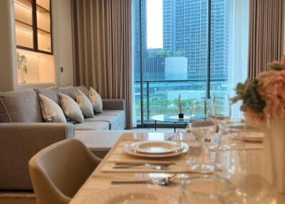 Modern living room with dining area and view of cityscape