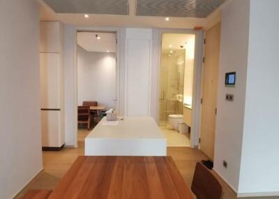 Modern bathroom with wooden flooring leading into dining and kitchen area