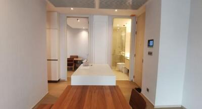 Modern bathroom with wooden flooring leading into dining and kitchen area