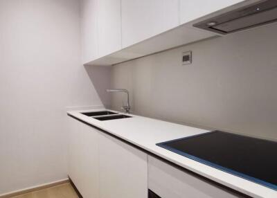 Modern compact kitchen with sleek white cabinetry