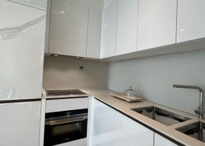 Modern kitchen with white cabinets and integrated appliances