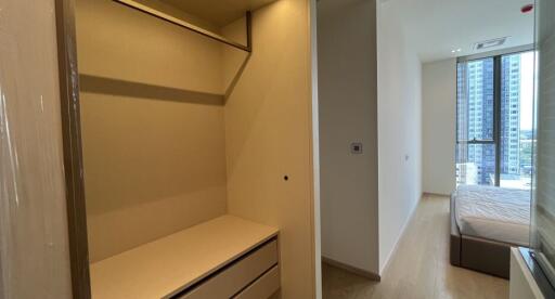 Spacious bedroom with walk-in closet and city view.