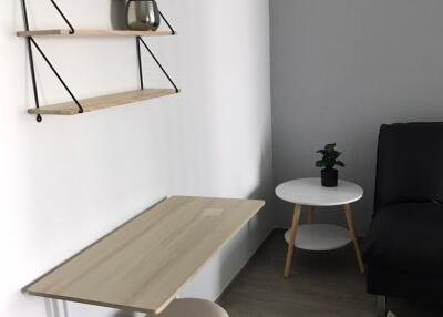 Small desk corner with shelves and seating area