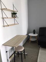 Small desk corner with shelves and seating area