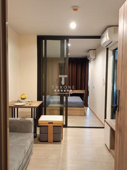 Modern living area with sliding glass door to bedroom