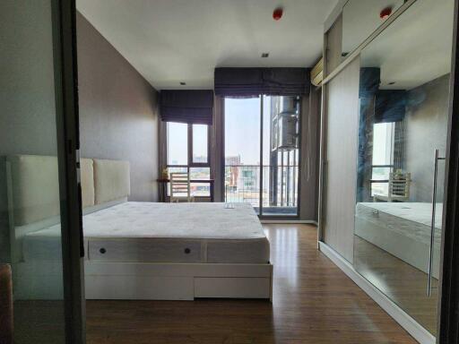 Spacious modern bedroom with large bed and balcony view