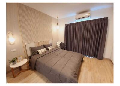 Modern bedroom with double bed, bedside tables, and air conditioning