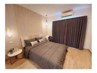 Modern bedroom with double bed, bedside tables, and air conditioning