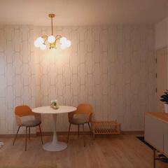 Cozy dining area with a small round table, modern chairs, and a stylish chandelier