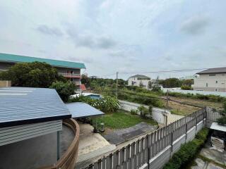 View of outdoor area with buildings, greenery, and sky