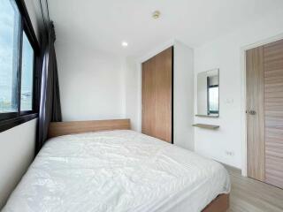 modern bedroom with large bed, wardrobe, mirror and window