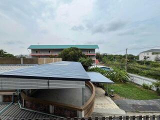 View of building with nearby structures and outdoor space