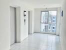 Bright hallway with white tiles and an elevator entrance