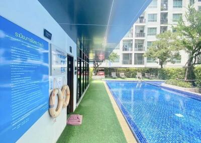 Outdoor pool area next to a modern building