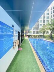 Outdoor pool area next to a modern building