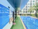 Outdoor pool area next to a modern building