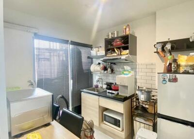 Compact kitchen with essential appliances and storage space
