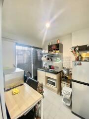 Compact kitchen with essential appliances and storage space