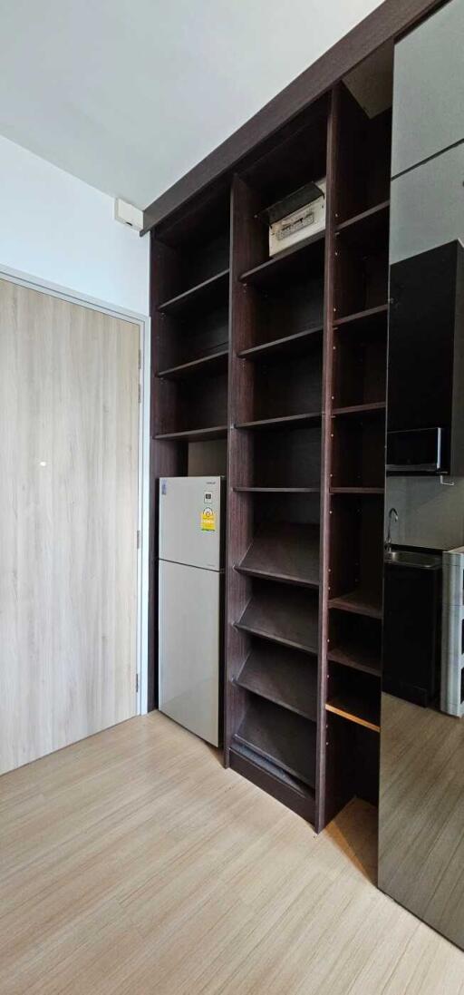 Kitchen with wooden storage and fridge