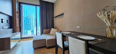 Modern living area with large windows and a small dining table