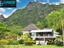 Exterior view of Harmony Land & House property with surrounding greenery and mountains
