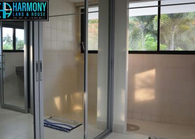 Spacious bathroom with glass shower enclosure and large window