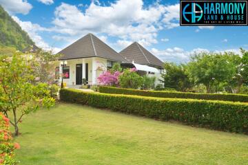 Exterior view of a property with garden and blue sky