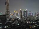 Night view of a city skyline with high-rise buildings and colorful lights