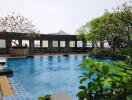 Outdoor swimming pool surrounded by lush greenery