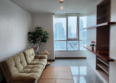 Spacious living room with a large window offering city views