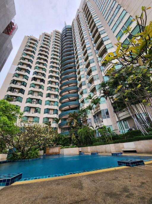 High-rise residential building exterior with swimming pool