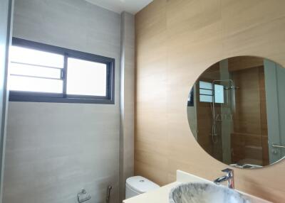 Modern bathroom with round mirror and vessel sink