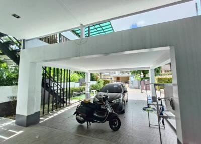 Covered garage space with motorcycle and car