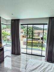 Bedroom with large windows and scenic view