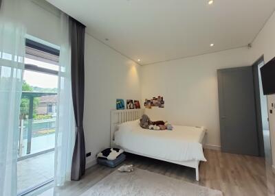 Spacious and bright bedroom with balcony access