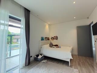 Spacious and bright bedroom with balcony access