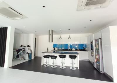 Modern kitchen with counter seating and large refrigerator