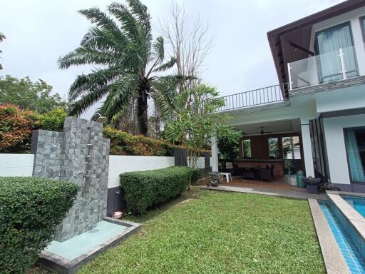 Outdoor view of a modern house with garden and pool