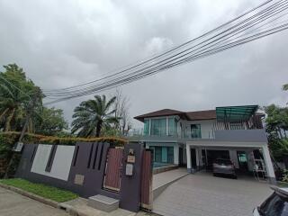 Modern two-story house with front yard and driveway