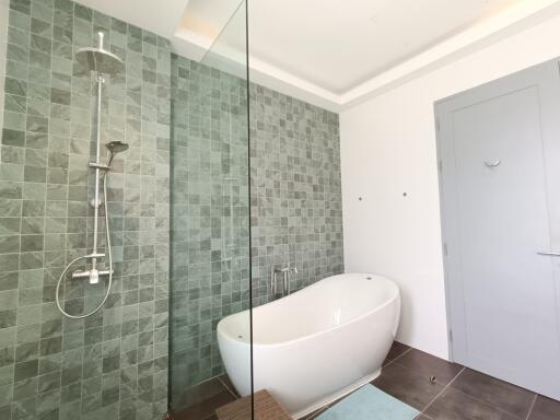 Modern bathroom with a large bathtub and wall-mounted shower