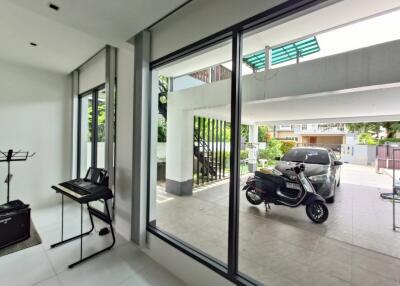 Spacious garage with natural lighting, containing a car and a motorcycle