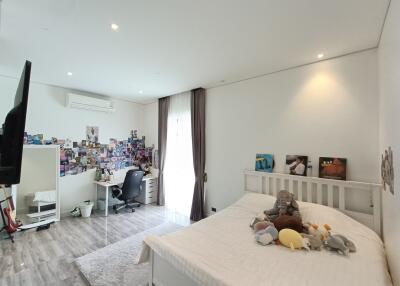 Spacious and well-lit bedroom with workspace