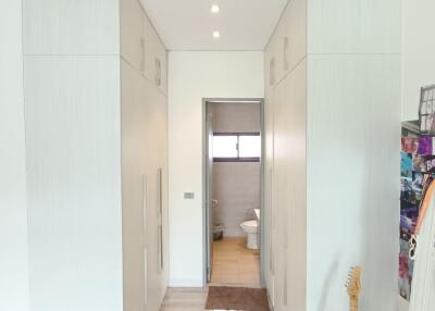 Hallway with visible bathroom entrance and guitar