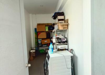 Utility room with shelf storage and appliances
