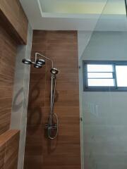 Modern bathroom with wooden accents and glass shower enclosure